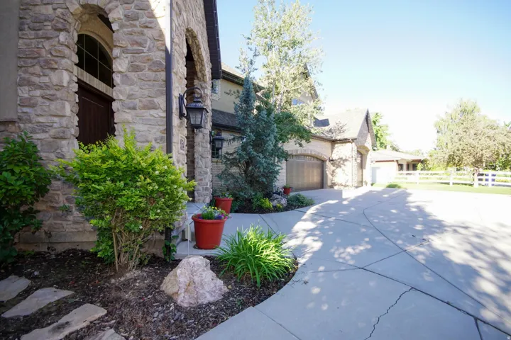 Stone facade entry with arched window and dark wood door