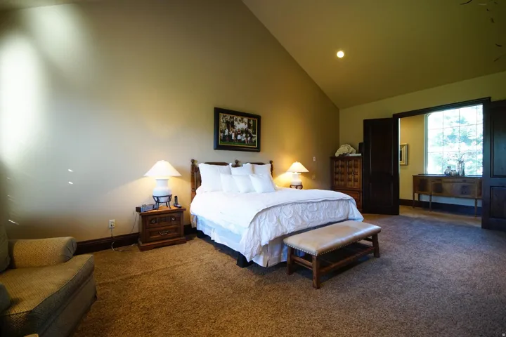 Vaulted ceiling room with recessed lighting and dark trim