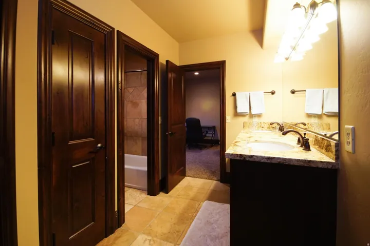 Dual vanity with stone countertop and individual sinks