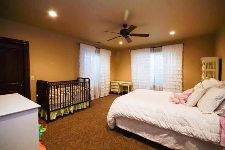 Carpeted room with recessed lighting and a ceiling fan