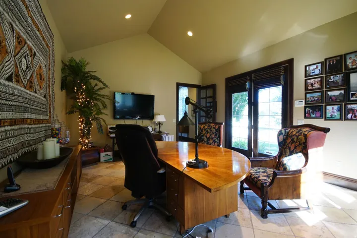 Vaulted ceiling room featuring light-toned tile flooring and recessed lighting