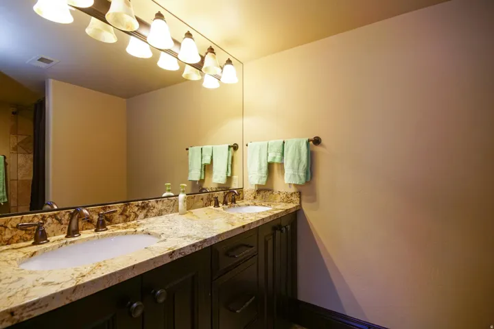 Double vanity with integrated sinks and bronze-finish fixtures