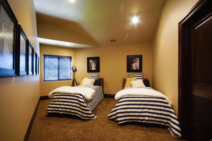 Carpeted room with recessed lighting and a single window featuring horizontal blinds
