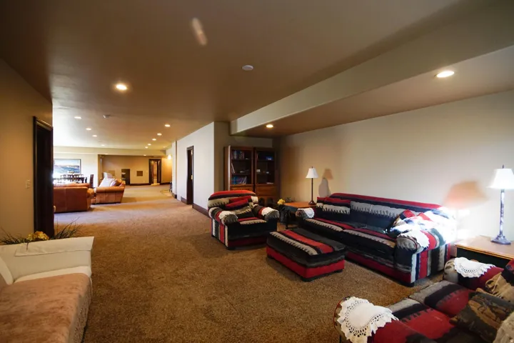 Expansive interior space featuring recessed lighting, a neutral color palette, and wall-to-wall carpeting