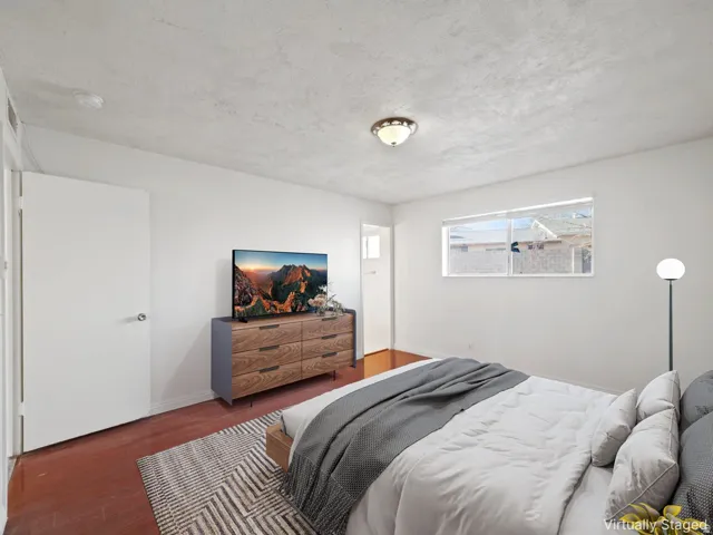 Warm wood-finish flooring complements the neutral wall tones