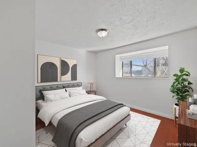 Bright room featuring wood-finish flooring, a contemporary semi-flush mount ceiling fixture, and a large window with white blinds