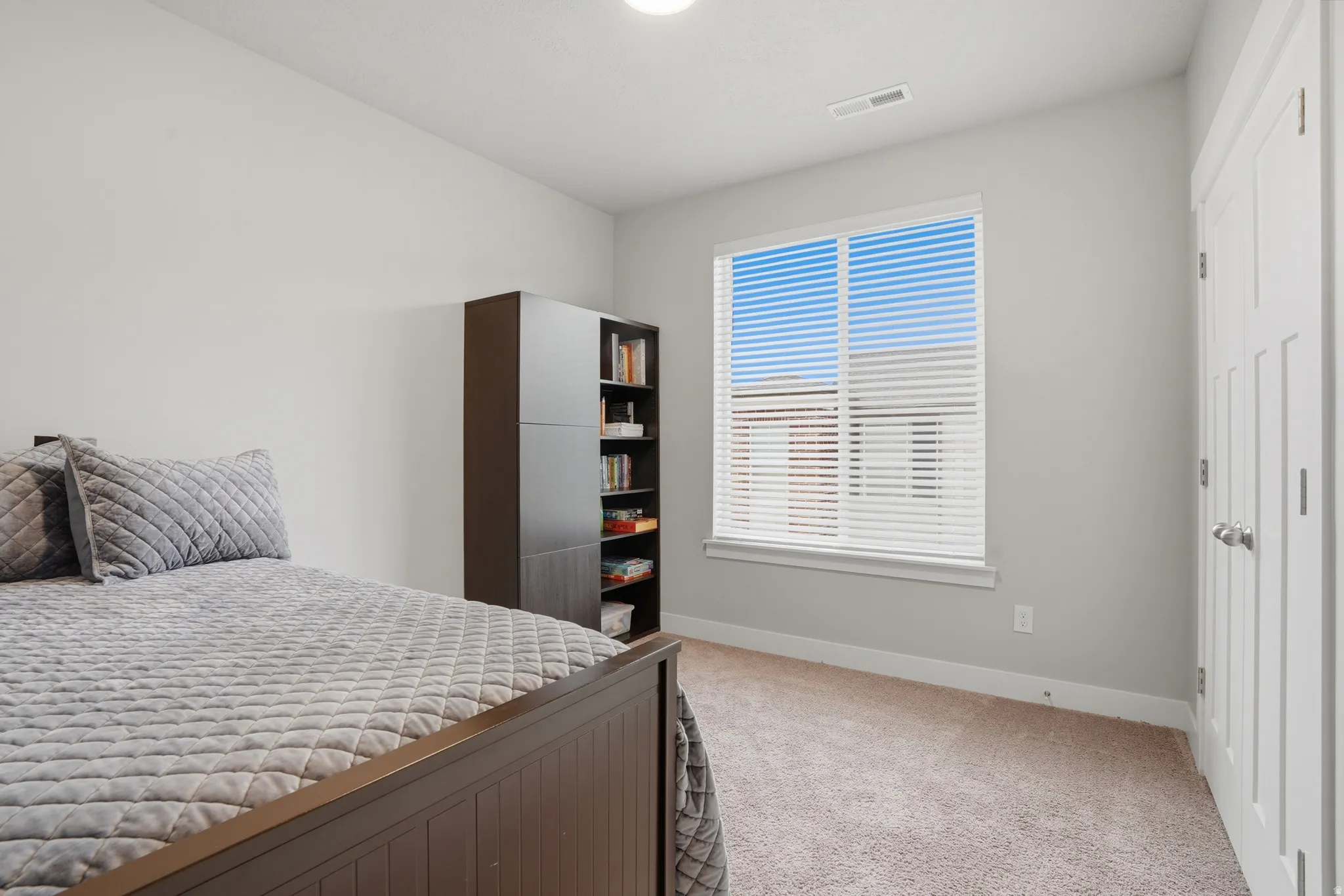 Room featuring light gray wall paint, a single window with white blinds, white trim, and a ceiling light fixture