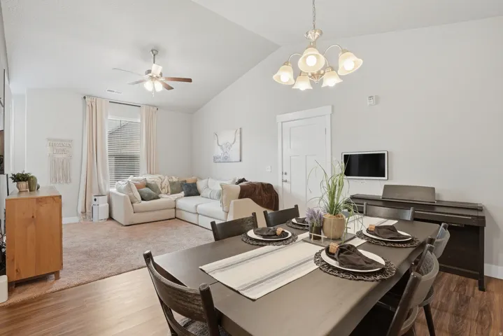Open-concept living and dining areas featuring vaulted ceilings