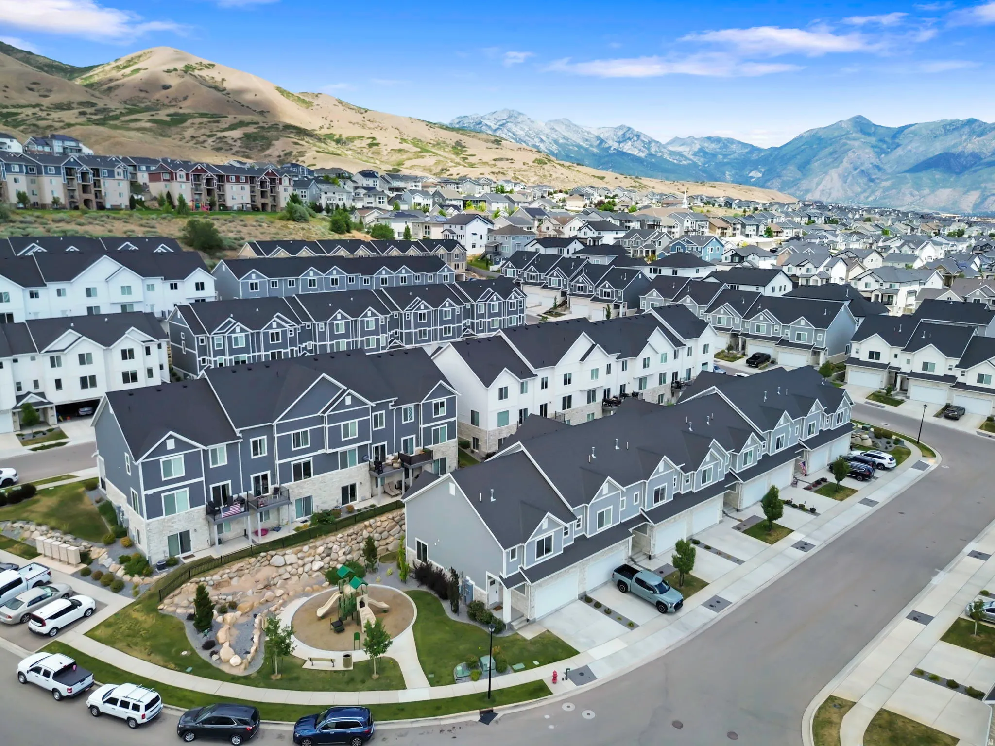 Modern townhome community featuring varied exterior finishes and a central recreational area