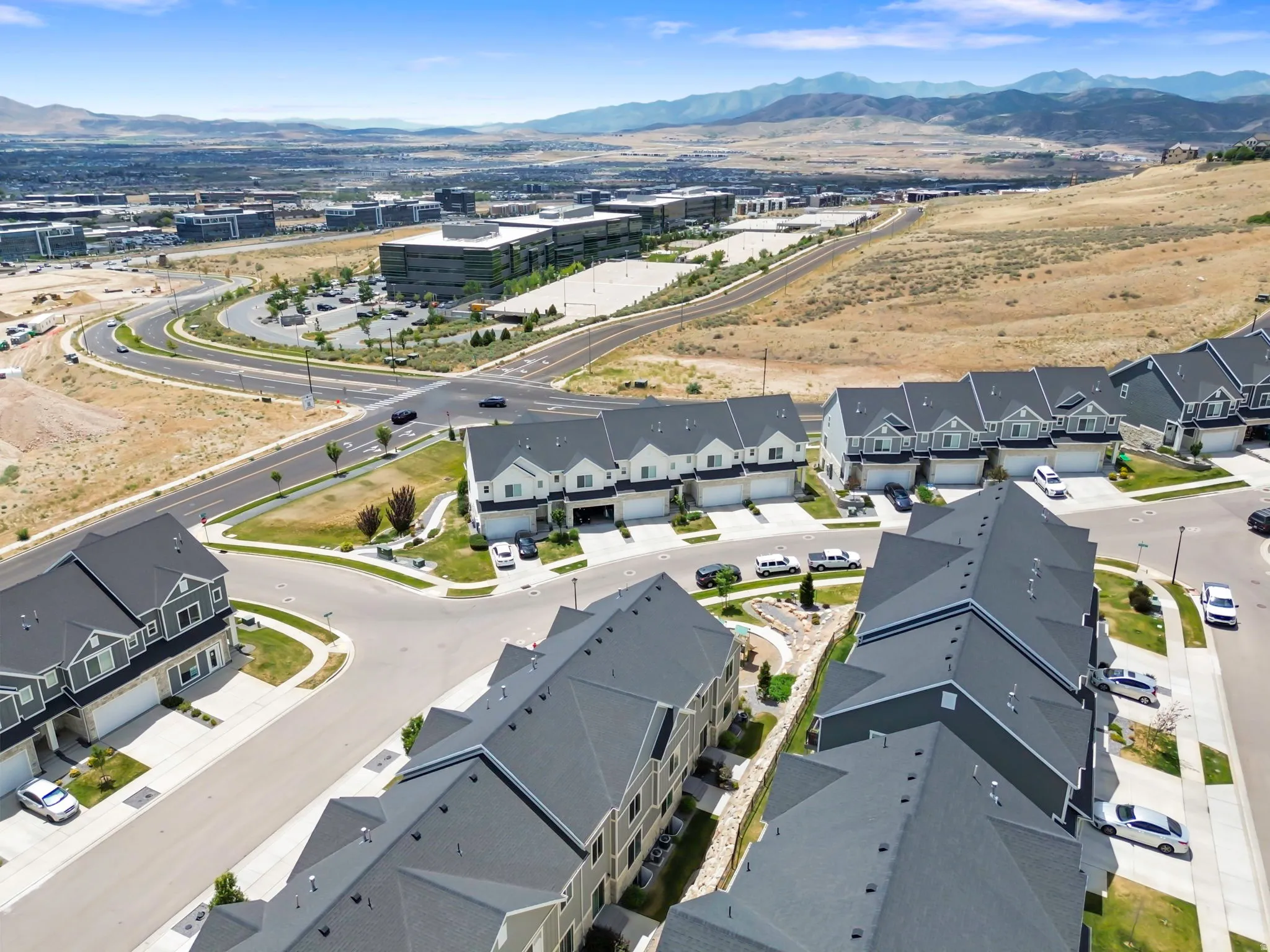 Aerial perspective showcasing townhome community with mountain backdrop
