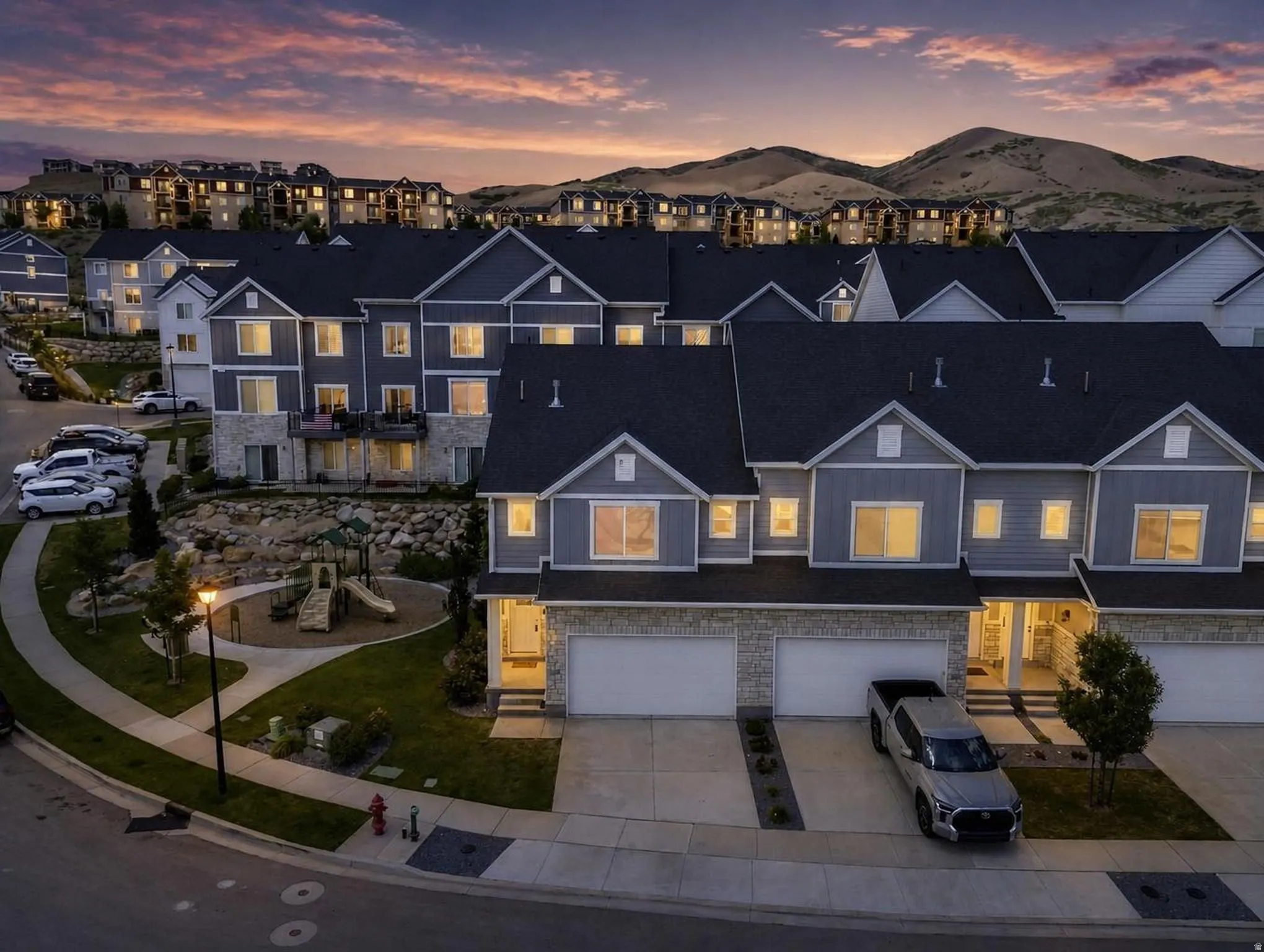 Modern townhome community featuring blue-gray siding and stone accents