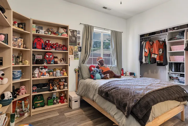 Bedroom featuring light wood-style flooring and a closet