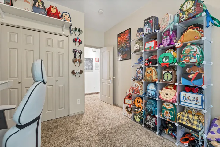 Home office with light colored carpet and baseboards