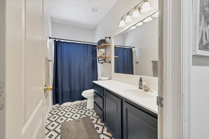 Full bathroom featuring vanity and toilet