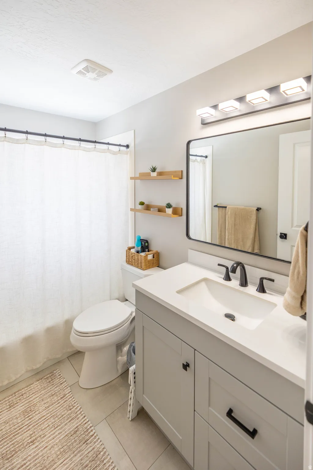 Bathroom with vanity and light tile patterned floors