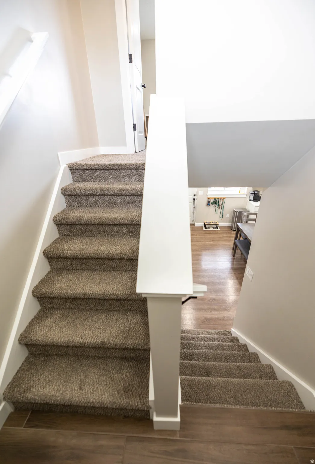 Staircase featuring wood finished floors and baseboards