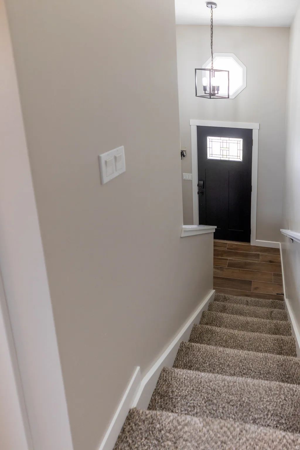 Stairs featuring baseboards and wood finished floors