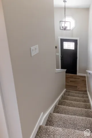Stairs featuring baseboards and wood finished floors