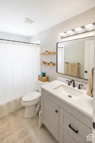 Bathroom with vanity and light tile patterned floors