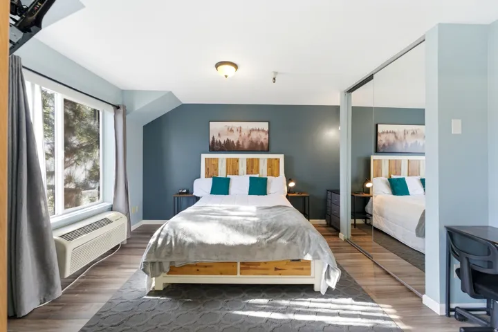 Spacious room featuring wood-finish flooring and a large window
