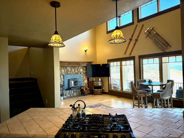 Kitchen with gas range oven, a high textured ceiling, and light countertops