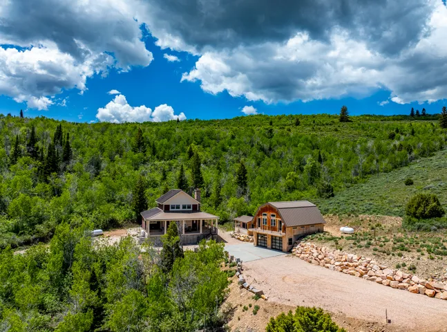 View from above of property with a heavily wooded area