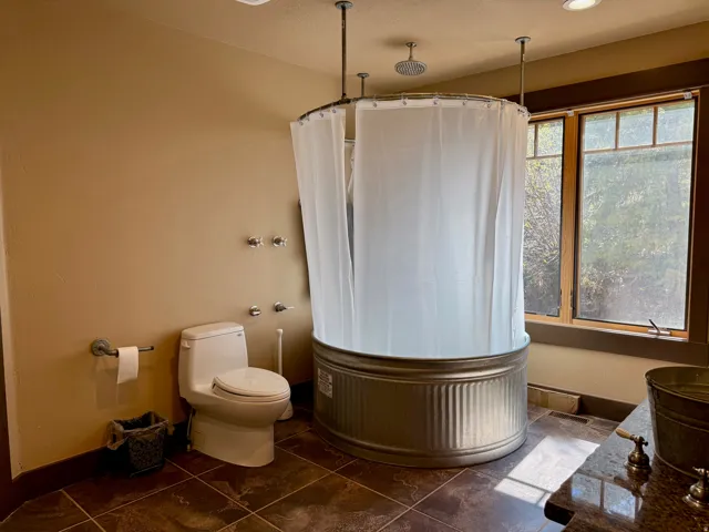 Primary bathroom with curtained shower and vanity