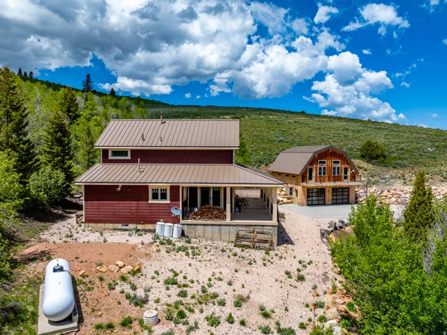 Rear view of property featuring a metal roof and crawl space
