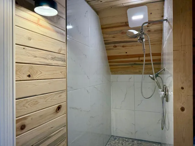 Bathroom with a vaulted wood ceiling and a walk in shower