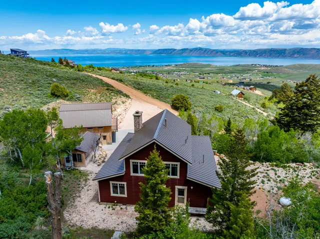 Aerial view of property and surrounding area featuring a water and mountain view
