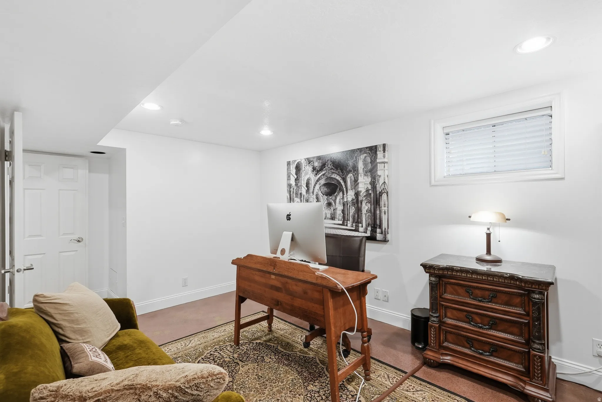 Recessed ceiling lighting, wood-finish flooring, white baseboards, and a single window with blinds