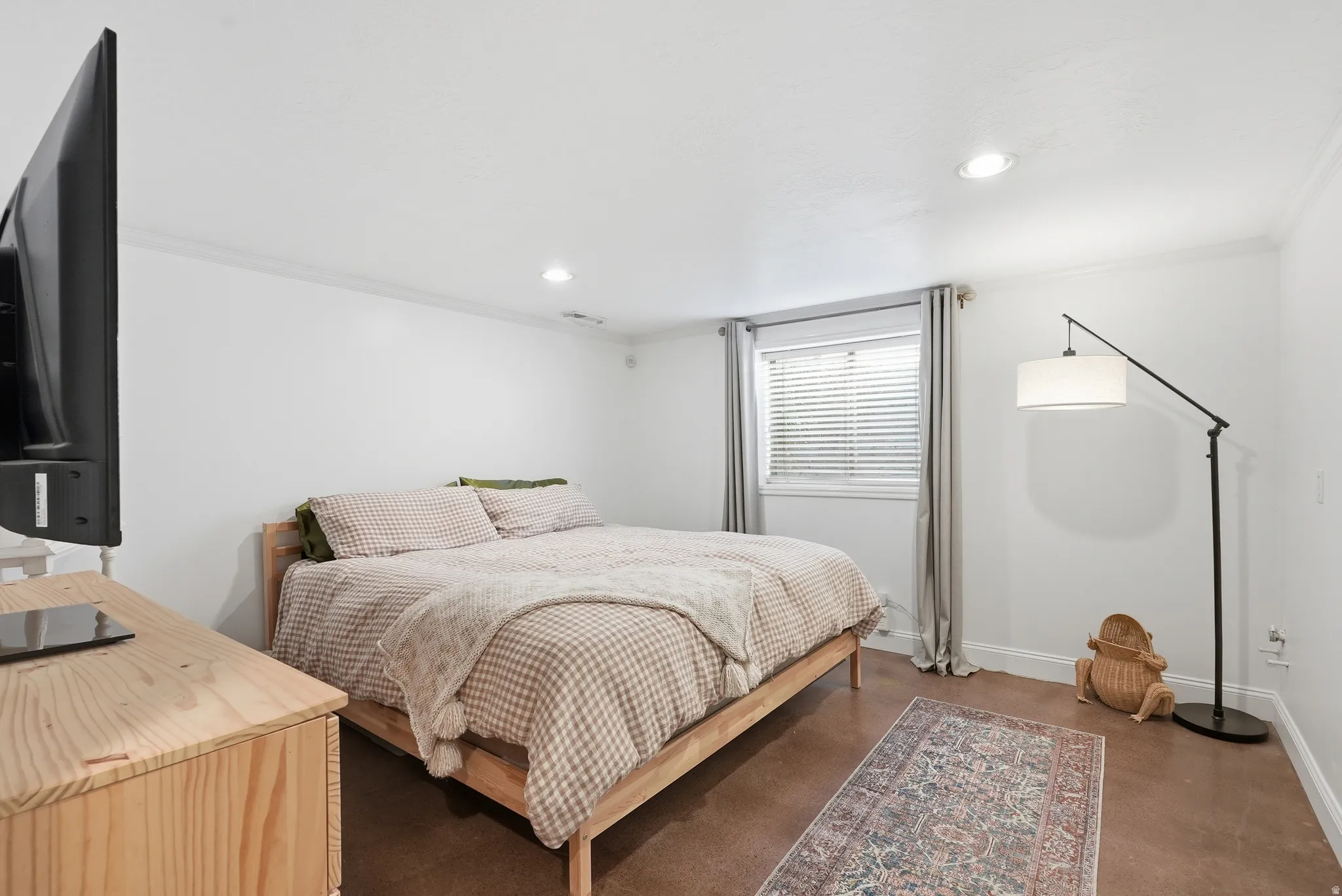 Neutral white walls with crown molding and recessed lighting