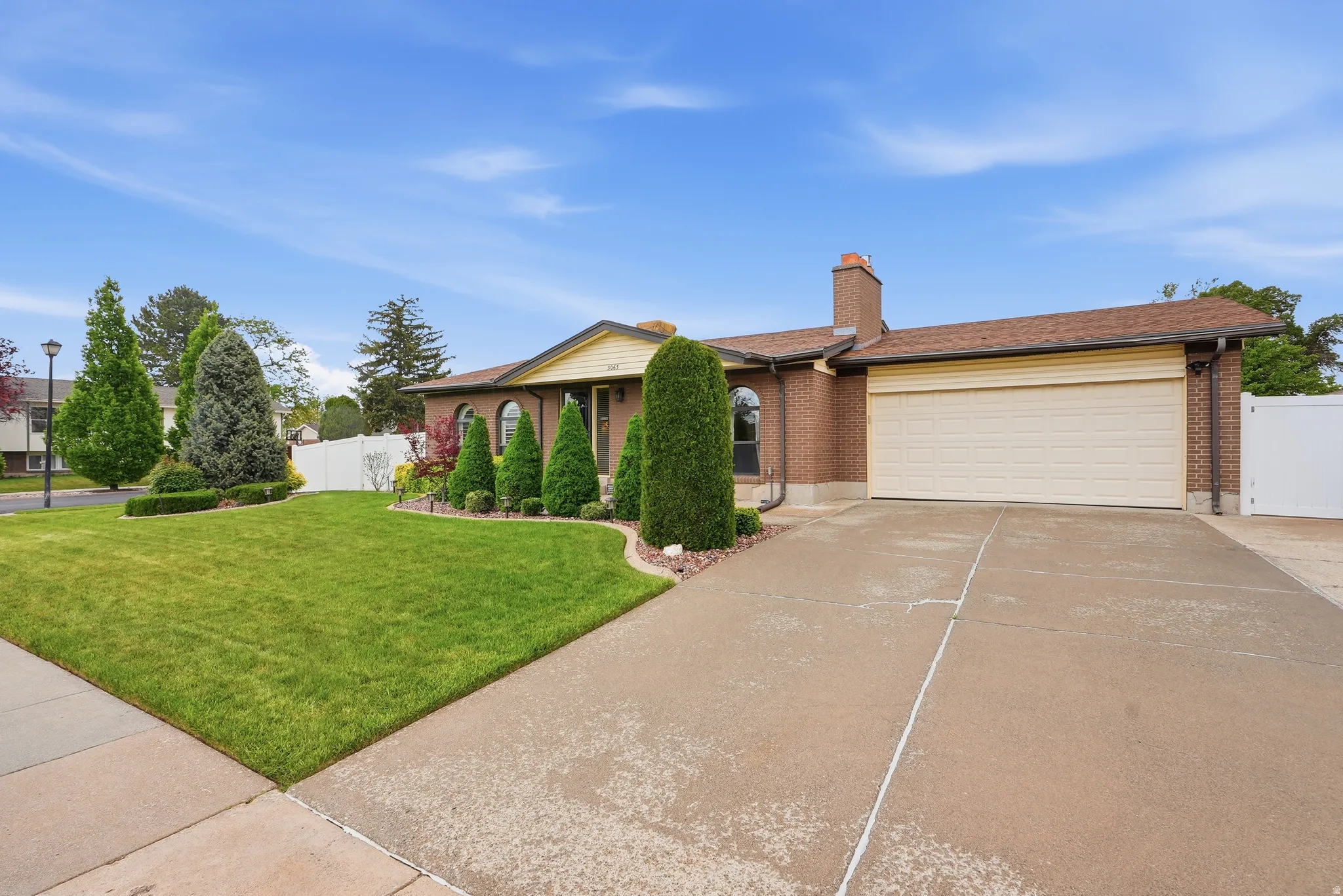 Brick facade residence featuring arched windows and a prominent front entrance
