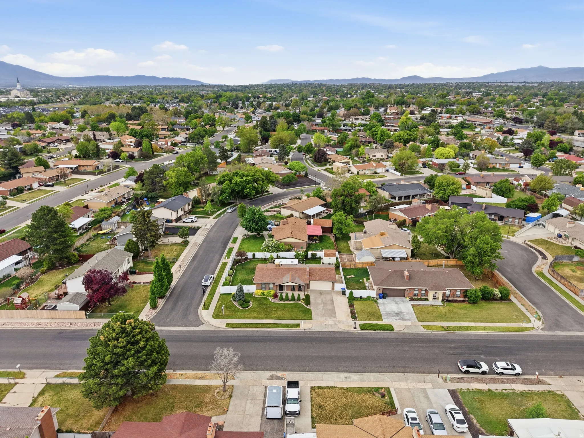 Aerial perspective of a residential neighborhood with a mountain backdrop