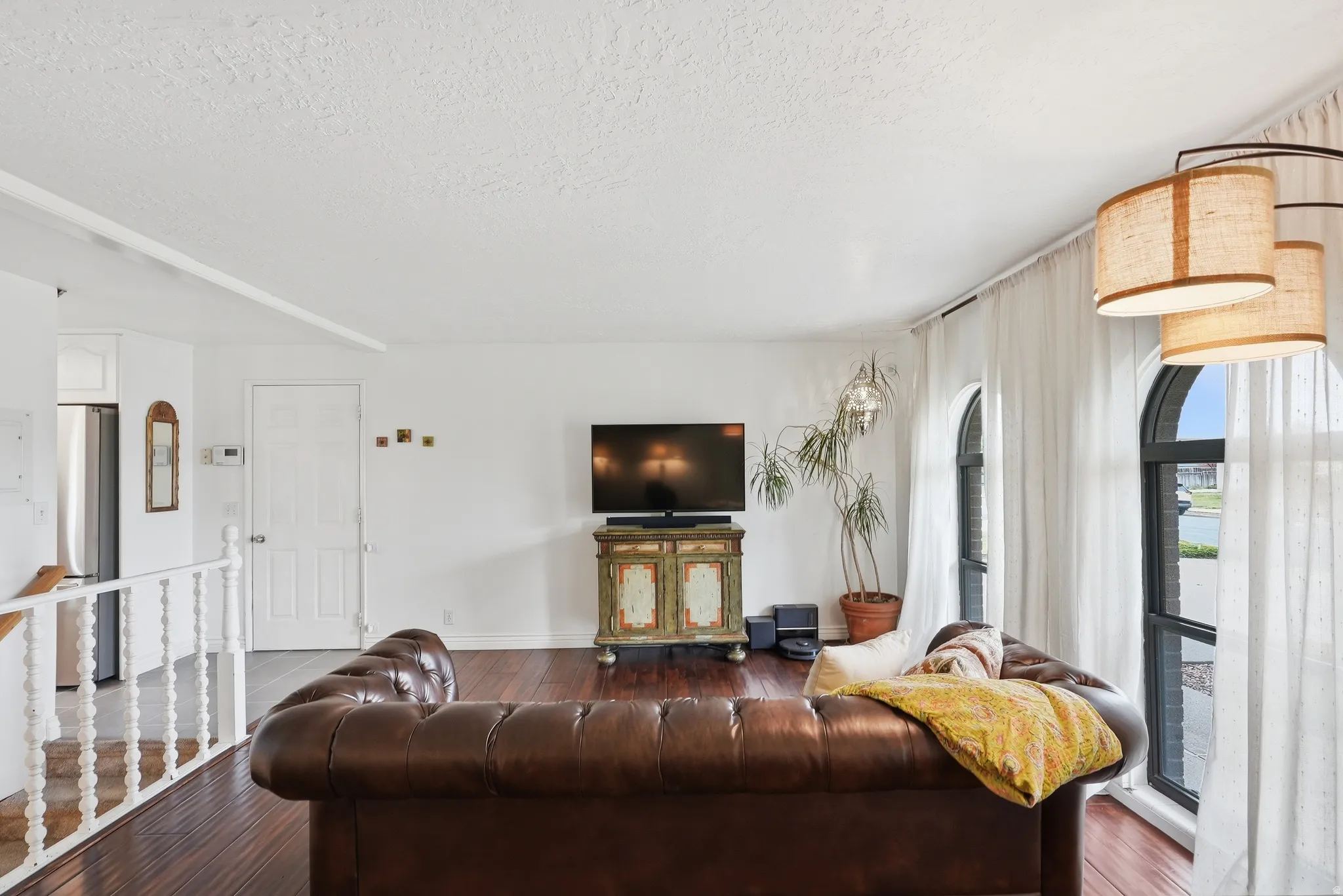 Living area featuring dark wood-finish flooring, white painted walls, and a white ceiling