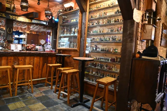 Custom bar area featuring rough-hewn wood paneling and a substantial wooden countertop