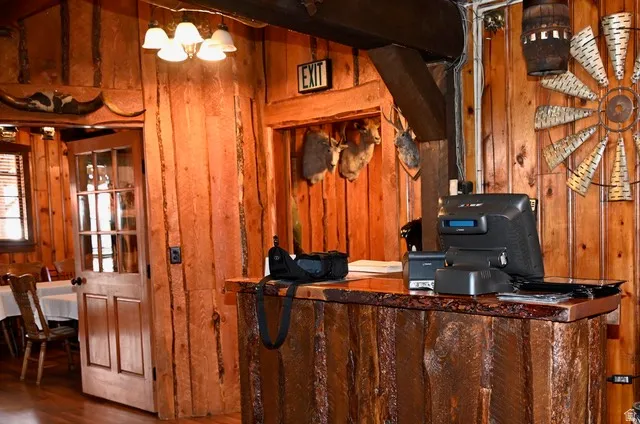 Wood-paneled interior featuring a rustic-style counter with a live-edge wood top