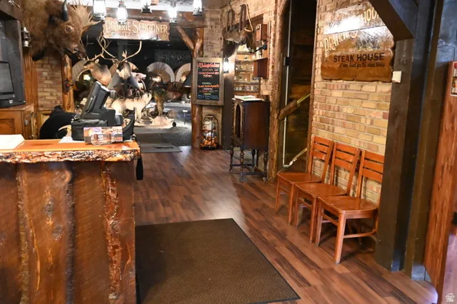 Rustic wood-finish flooring complemented by exposed brick walls