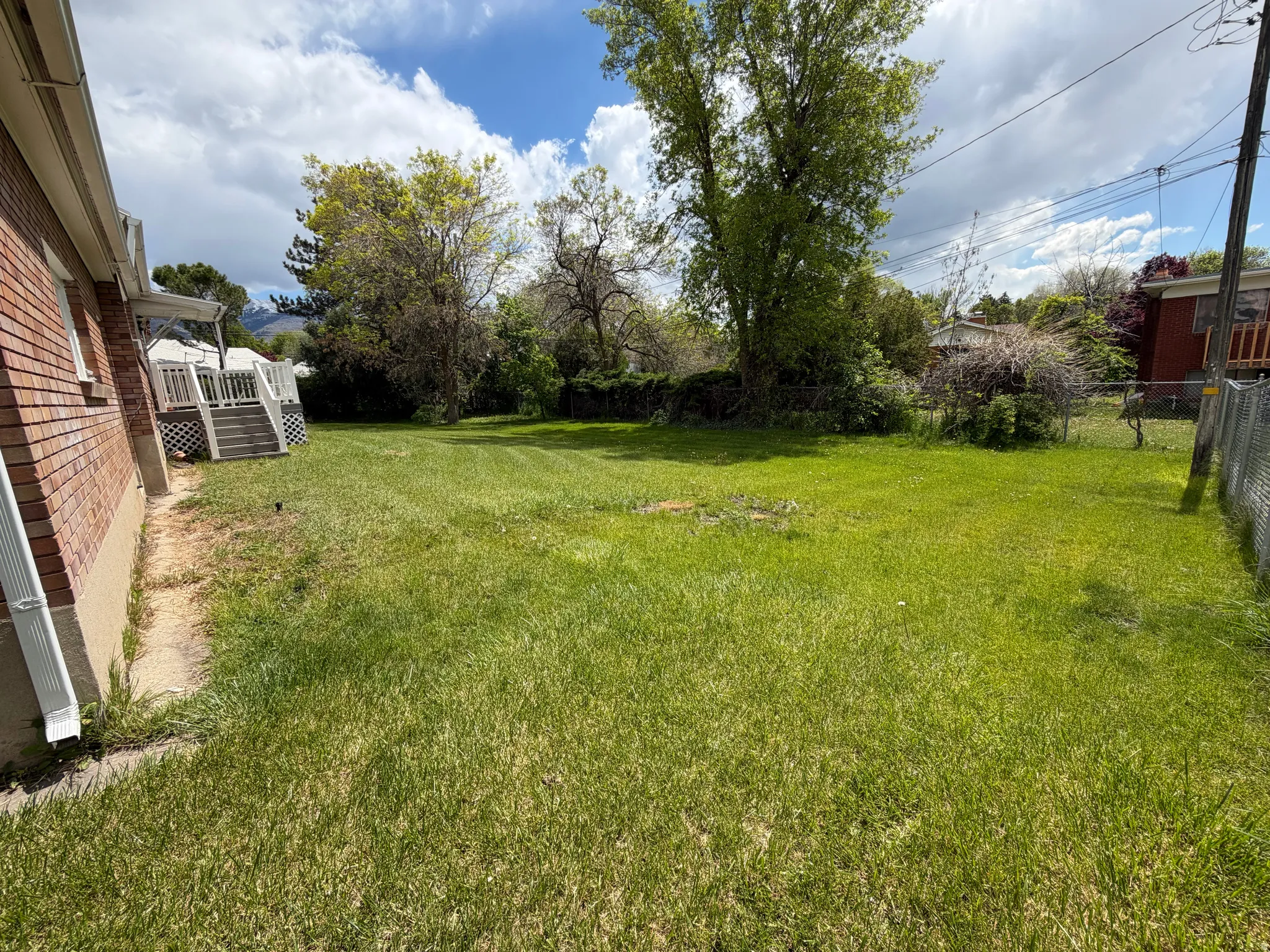 Expansive lawn area with mature perimeter trees