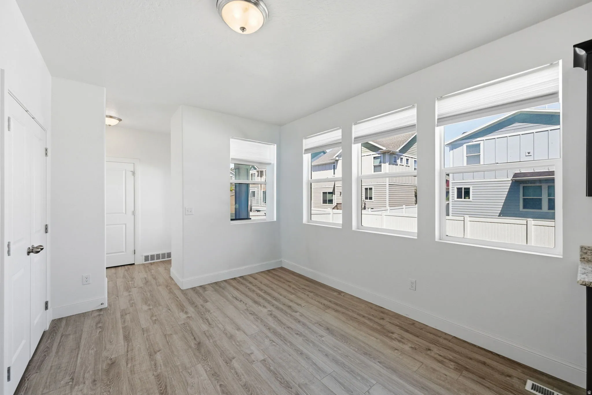 Unfurnished room featuring light wood-type flooring and baseboards