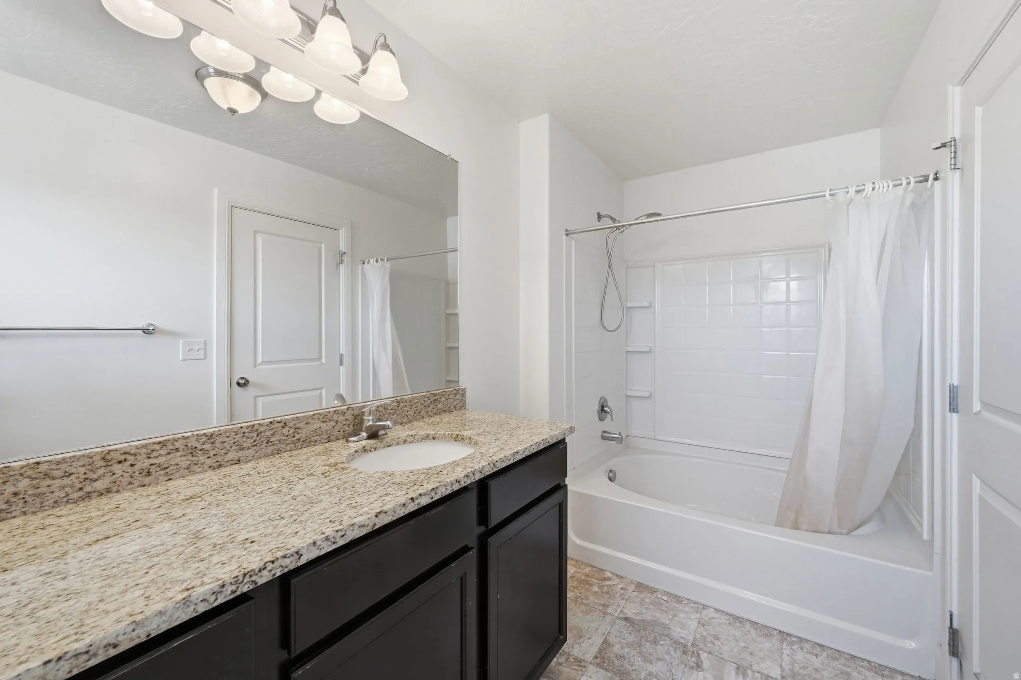 Bathroom featuring vanity and shower / tub combo