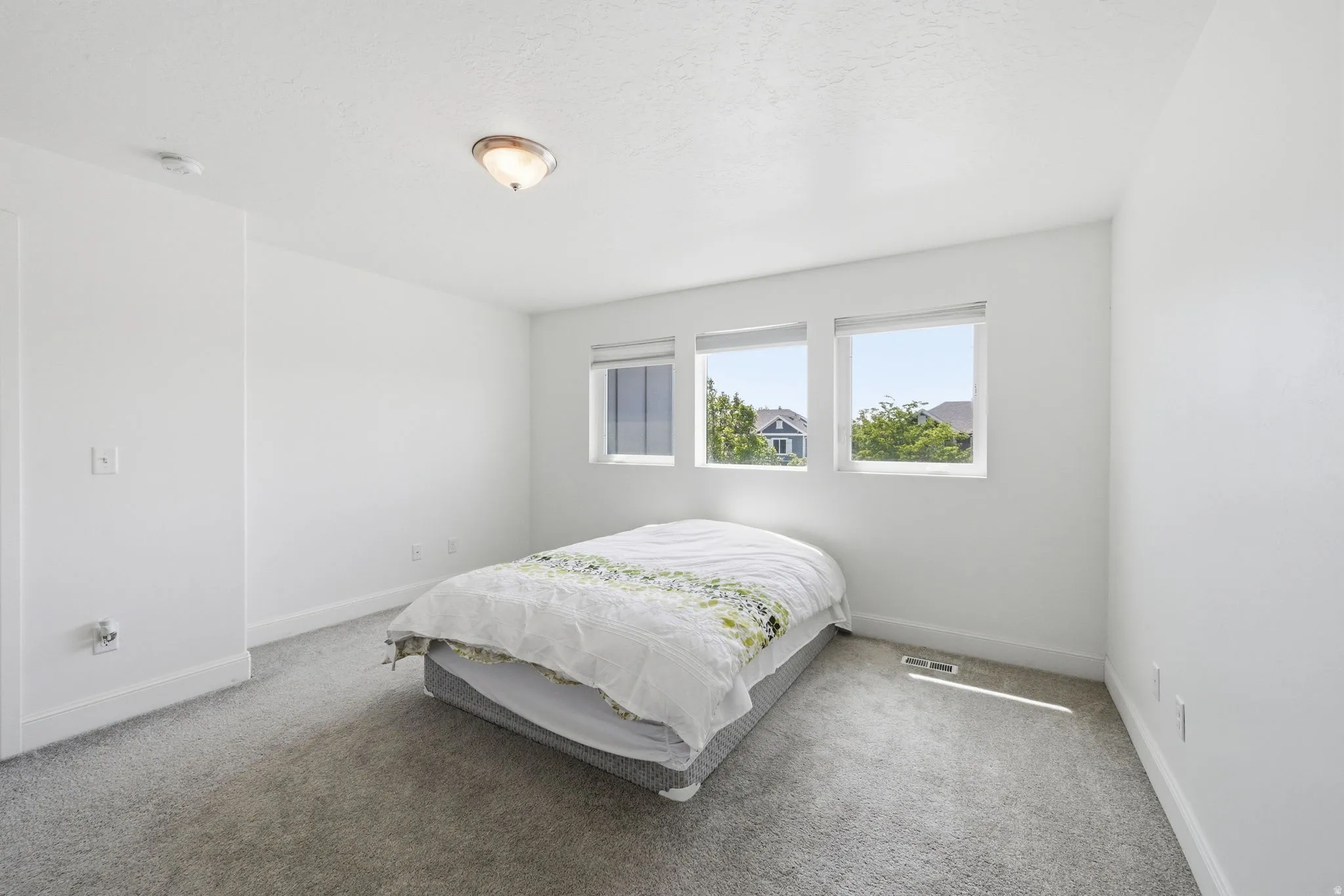 Carpeted bedroom with baseboards