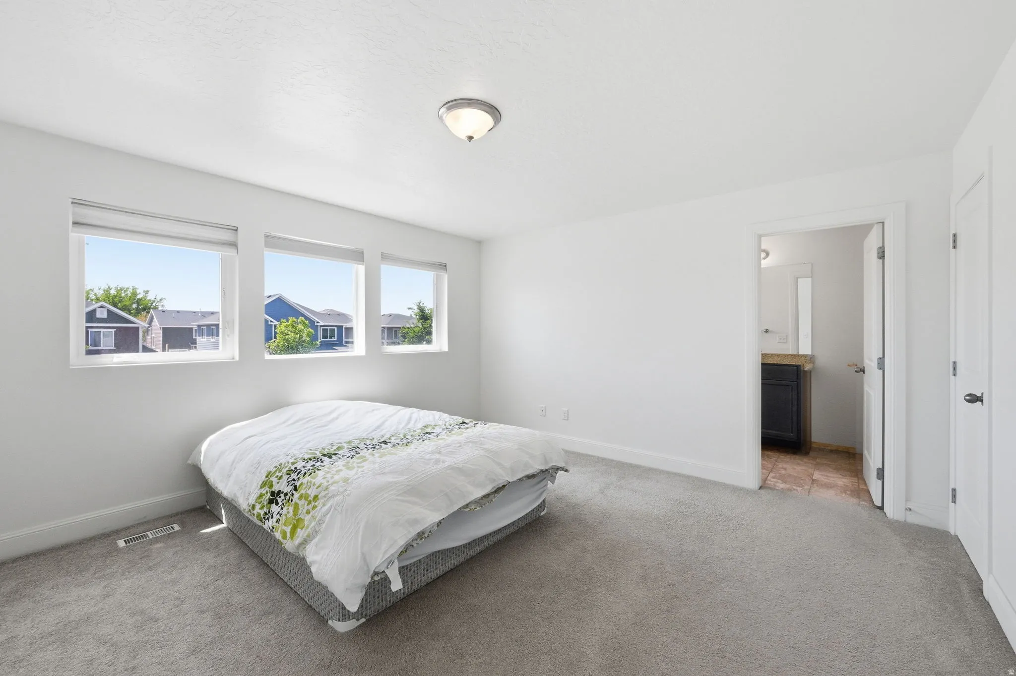 Bedroom featuring carpet and connected bathroom