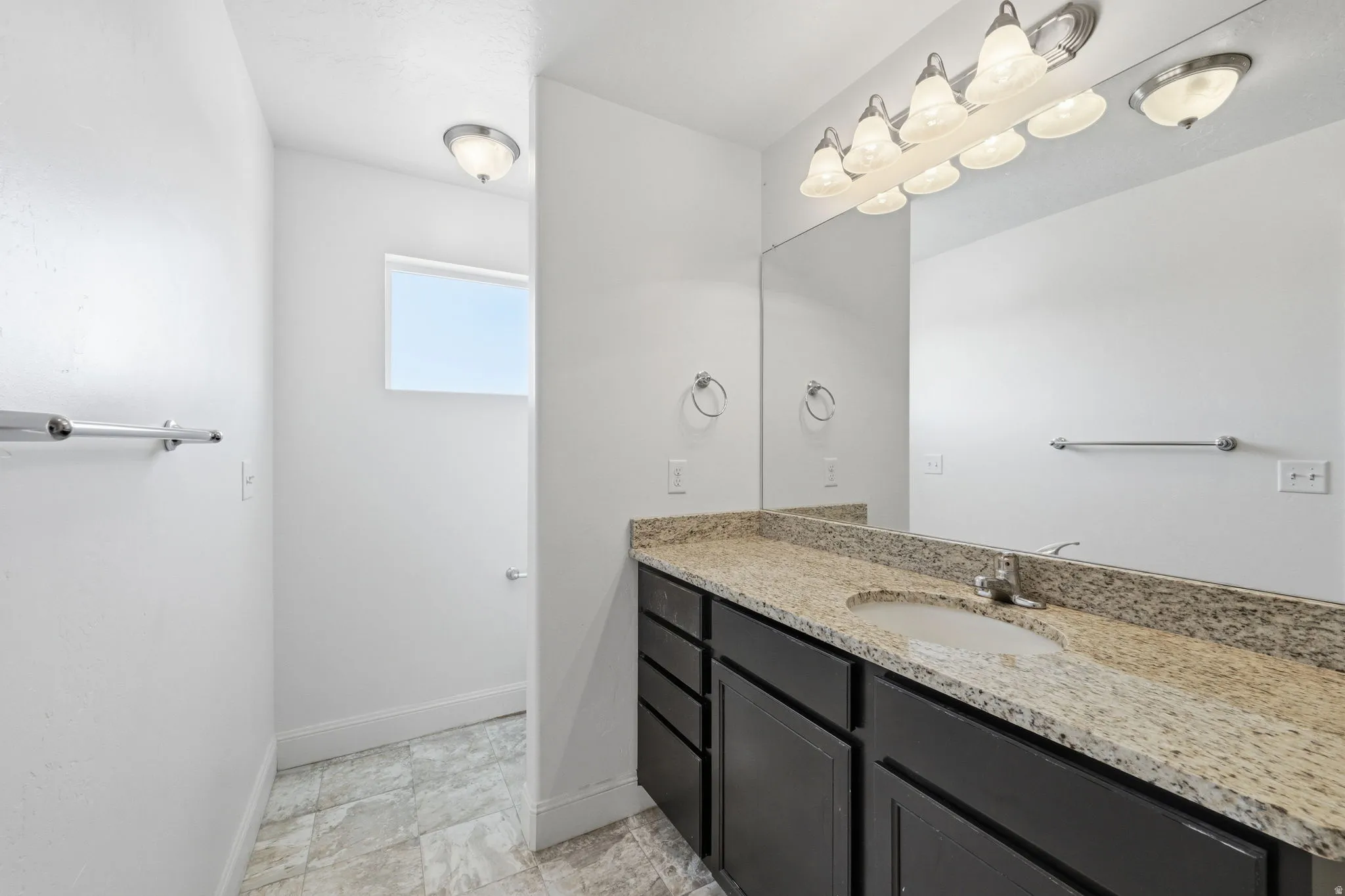 Bathroom featuring vanity and baseboards