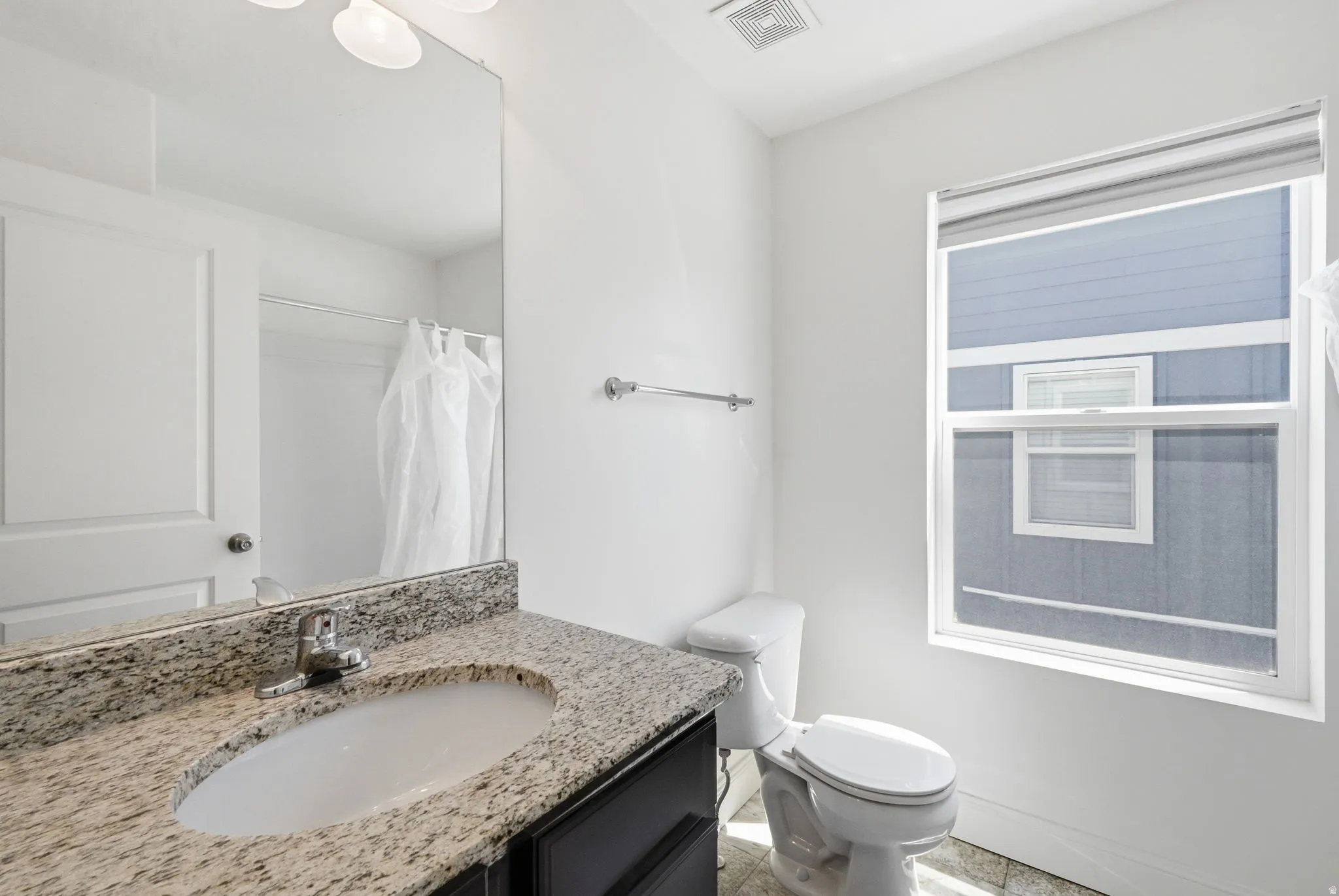Full bathroom featuring vanity and a shower with shower curtain