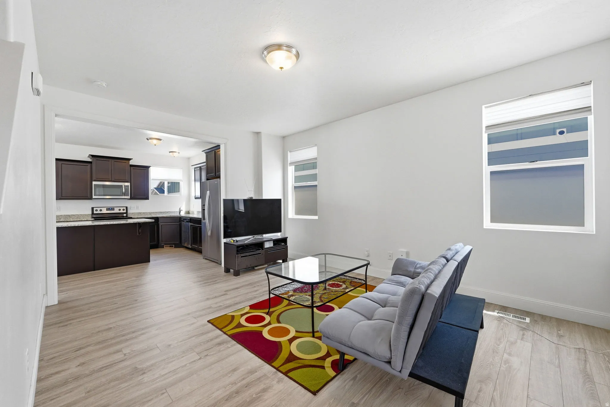 Living area featuring light wood finished floors and baseboards