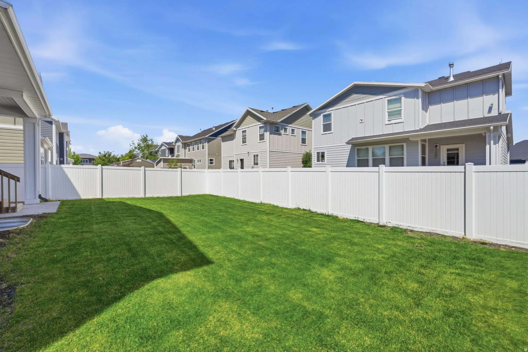 Fenced backyard featuring a residential view