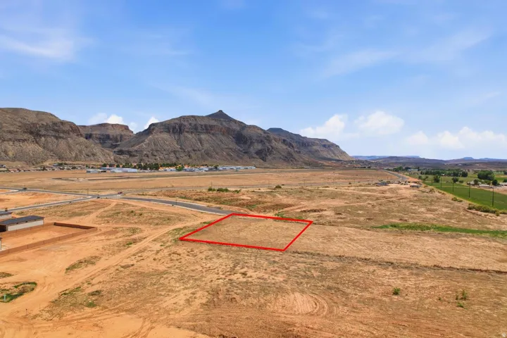 Expansive vacant lot featuring a flat topography, natural vegetation, and distant mountain backdrops