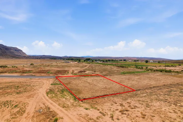 Expansive parcel of undeveloped land, featuring a flat topography and distant mountain backdrop