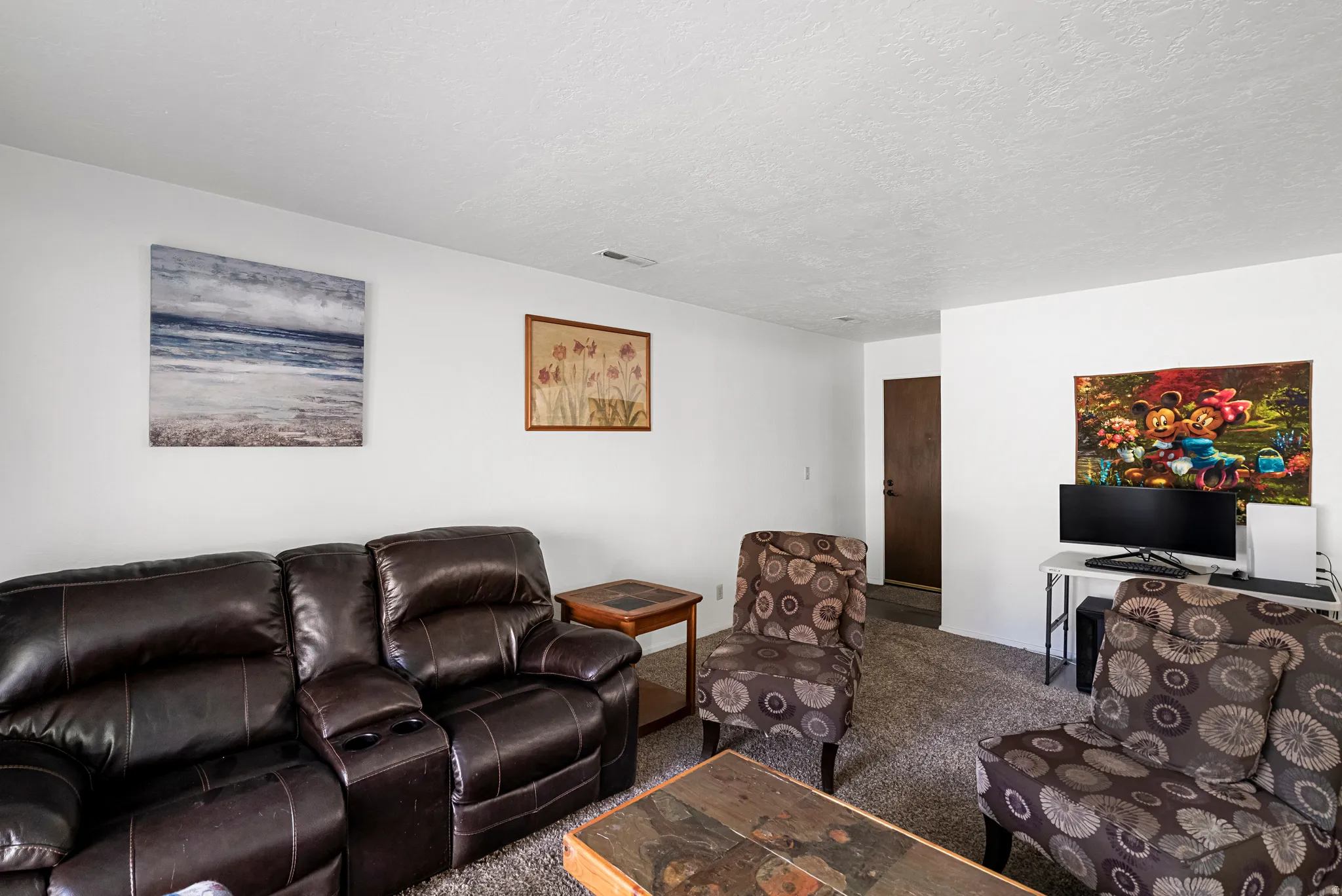 Neutral wall finishes complement the textured carpeting